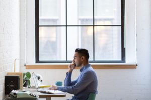 man at desk near window